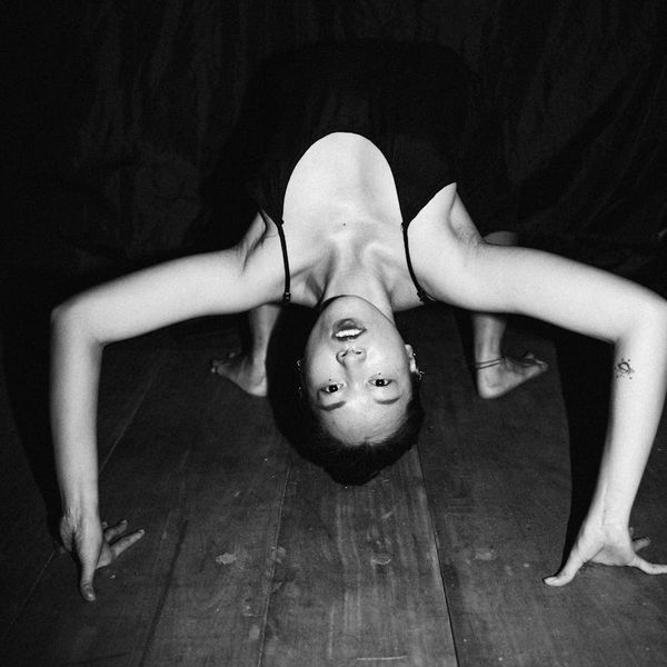 Person stretching peacefully with a calm and focused expression.